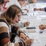 Uczestniczka pisząca stalówką na papierze