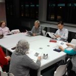 Grupa osób siedzi przy stoliku